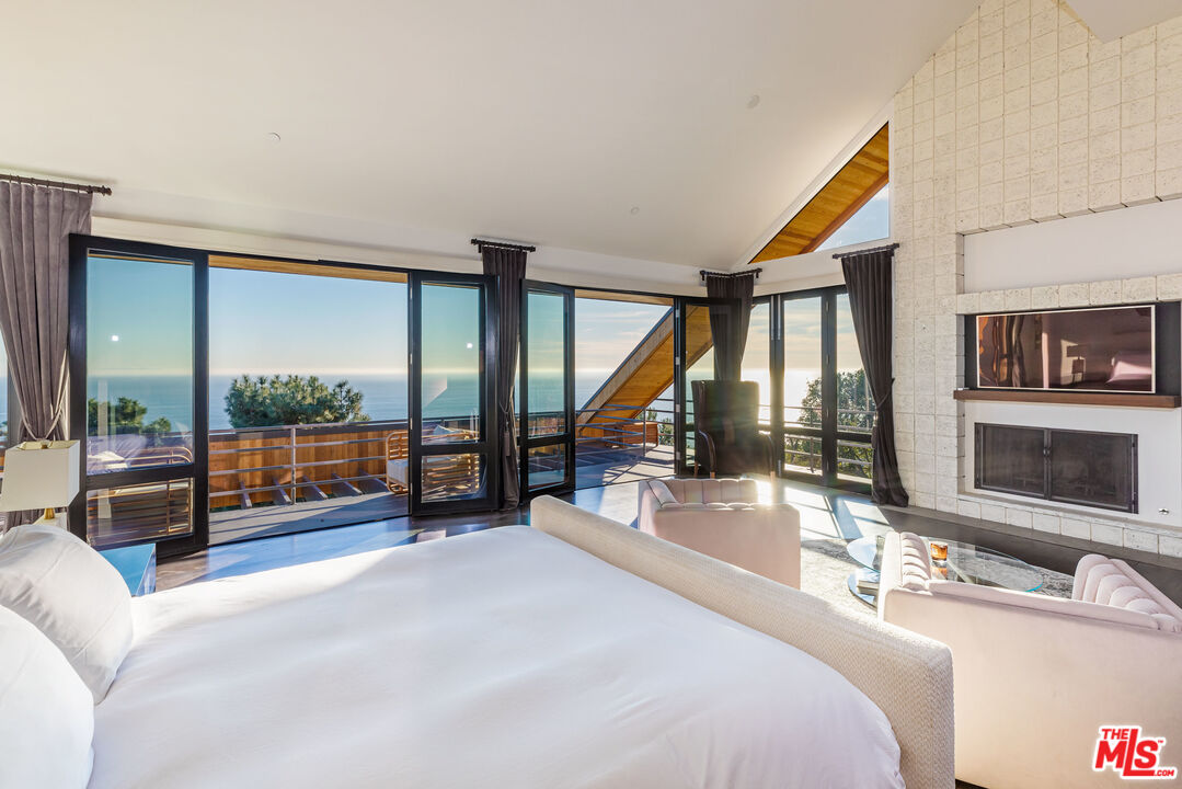 3900 Villa Costera Malibu, CA 90265 - Photo 20 of 43 a bedroom with furniture and a large window