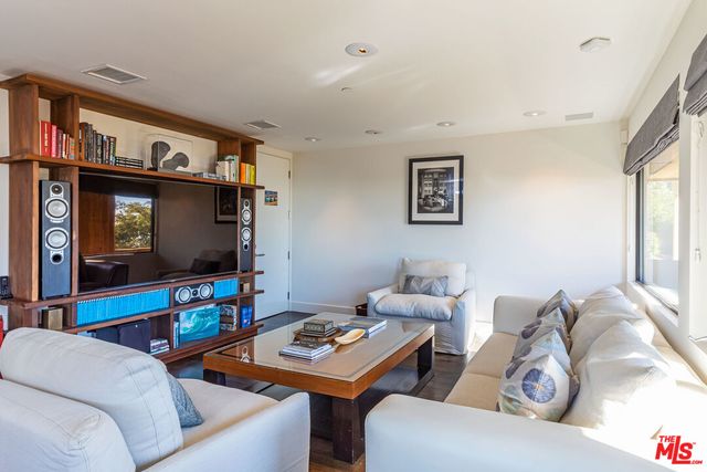 a living room with furniture and a gym machine