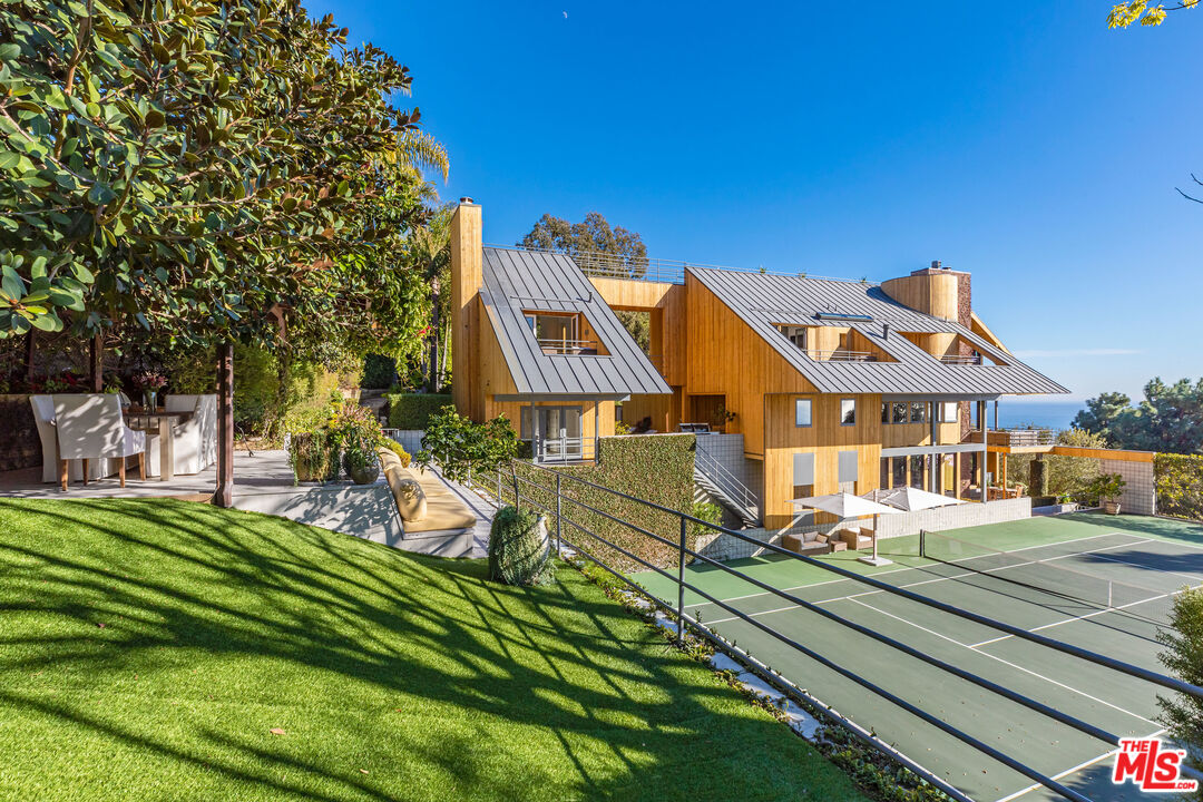 3900 Villa Costera Malibu, CA 90265 - Photo 28 of 43 a front view of a house with a yard