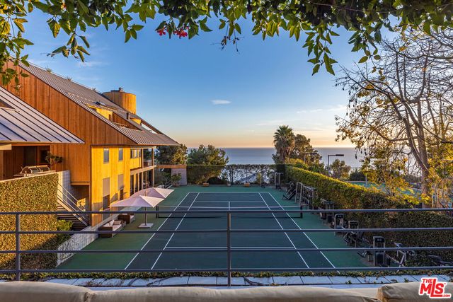 a view of a patio with table and chairs a barbeque with wooden floor and roof