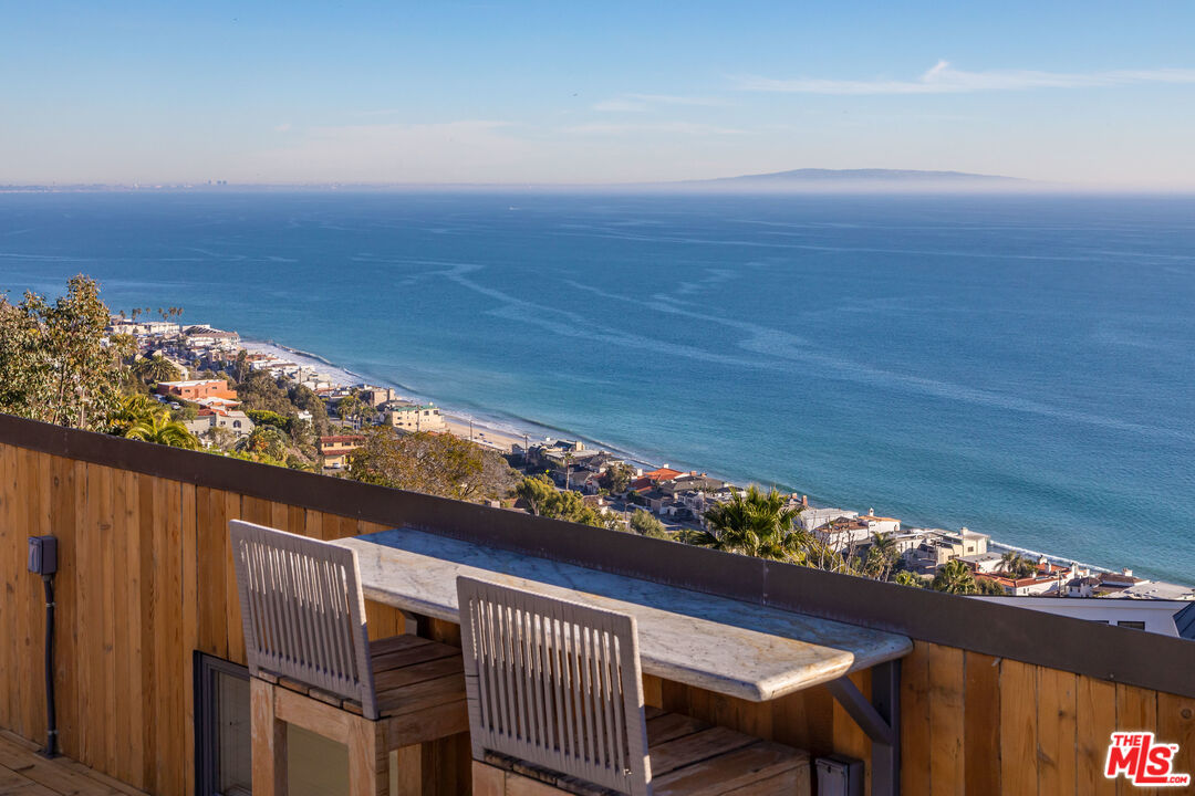 3900 Villa Costera Malibu, CA 90265 - Photo 35 of 43 a view of a chairs and table in the terrace