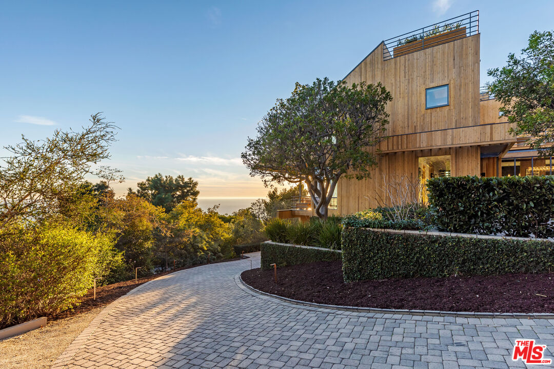 3900 Villa Costera Malibu, CA 90265 - Photo 41 of 43 a tall building with trees in the background