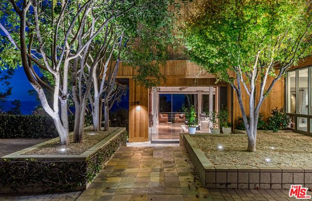 a view of a house with backyard porch and sitting area