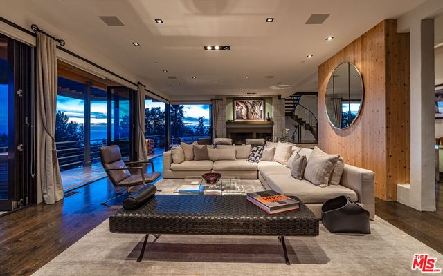a living room with furniture a rug and a large window