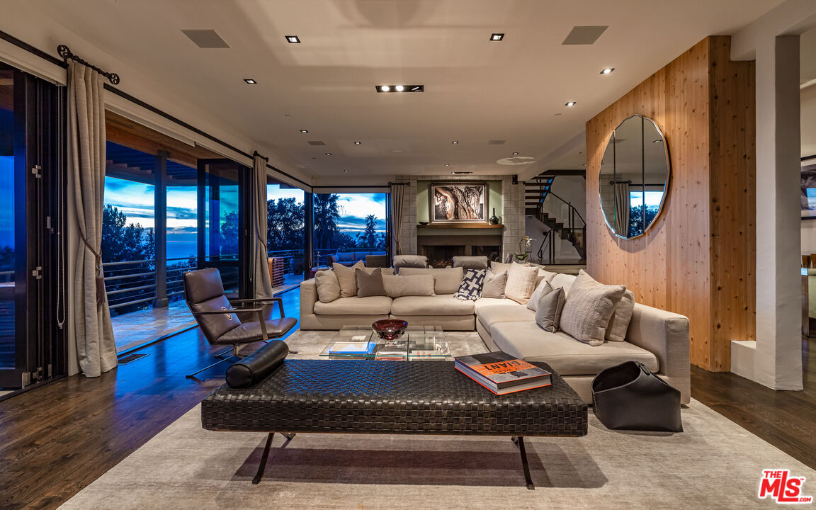 3900 Villa Costera Malibu, CA 90265 - Photo 9 of 43 a living room with furniture a rug and a large window