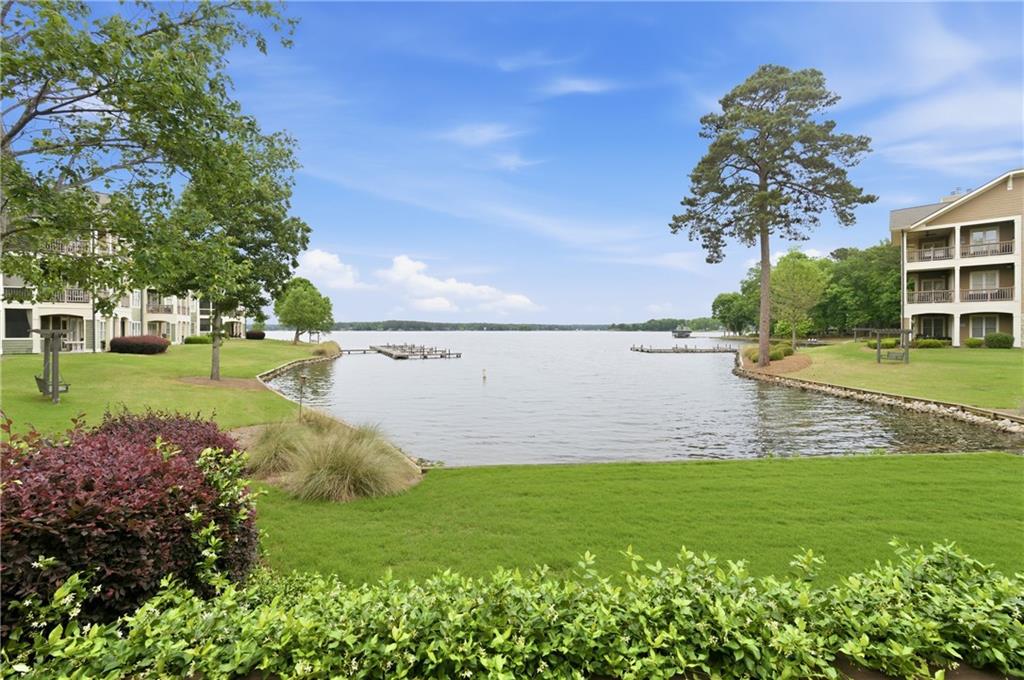 117 South Bay Road, Unit 402 Eatonton, GA 31024 - Photo 39 of 48 a view of a lake with a building in the background