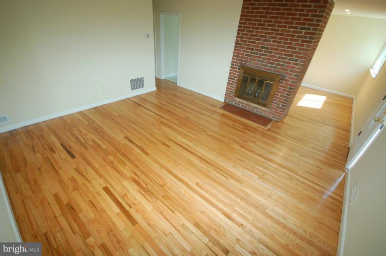 3612 Telmar Road Baltimore, MD 21207 - Photo 3 of 14 a view of empty room with wooden floor