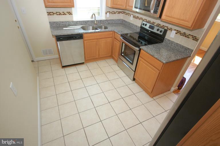 3612 Telmar Road Baltimore, MD 21207 - Photo 5 of 14 a kitchen with stainless steel appliances granite countertop a sink stove and cabinets