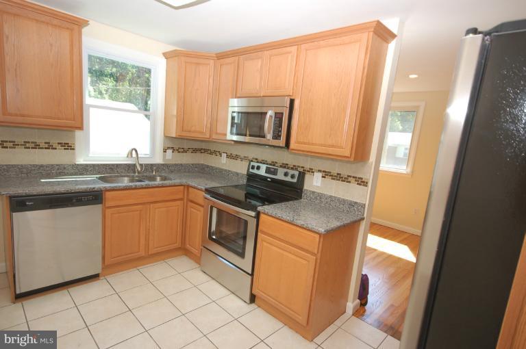 3612 Telmar Road Baltimore, MD 21207 - Photo 6 of 14 a kitchen with a sink stove and microwave