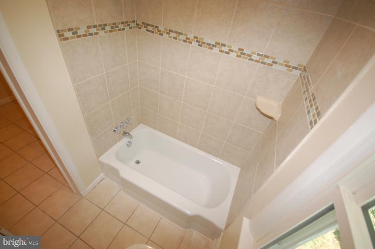 3612 Telmar Road Baltimore, MD 21207 - Photo 9 of 14 a bathroom with a white bath tub and a shower