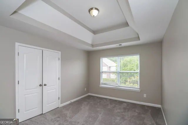 an empty room with windows and closet