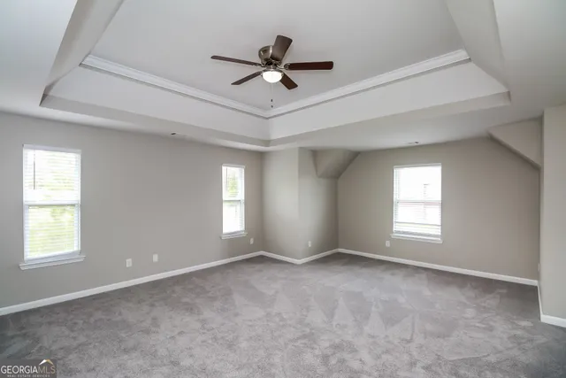 a view of a livingroom with a ceiling fan and window