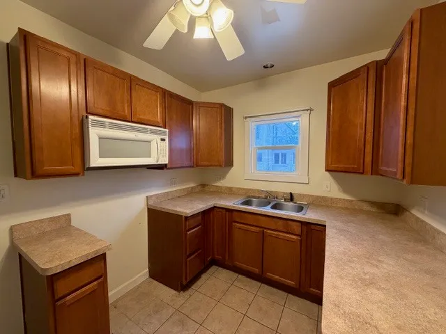 a kitchen with stainless steel appliances granite countertop wooden cabinets a sink and dishwasher