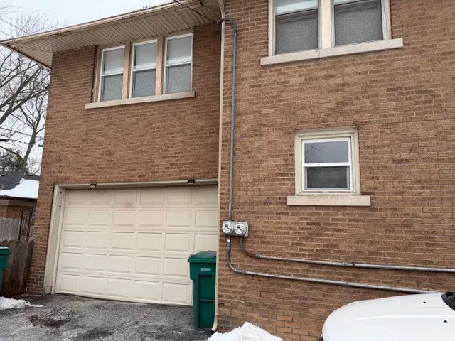a brick house with a bench in front of door