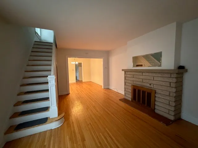 a view of a livingroom with wooden floor and fireplace
