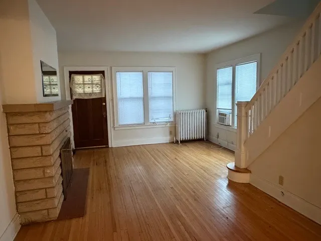 wooden floor in an empty room with a window