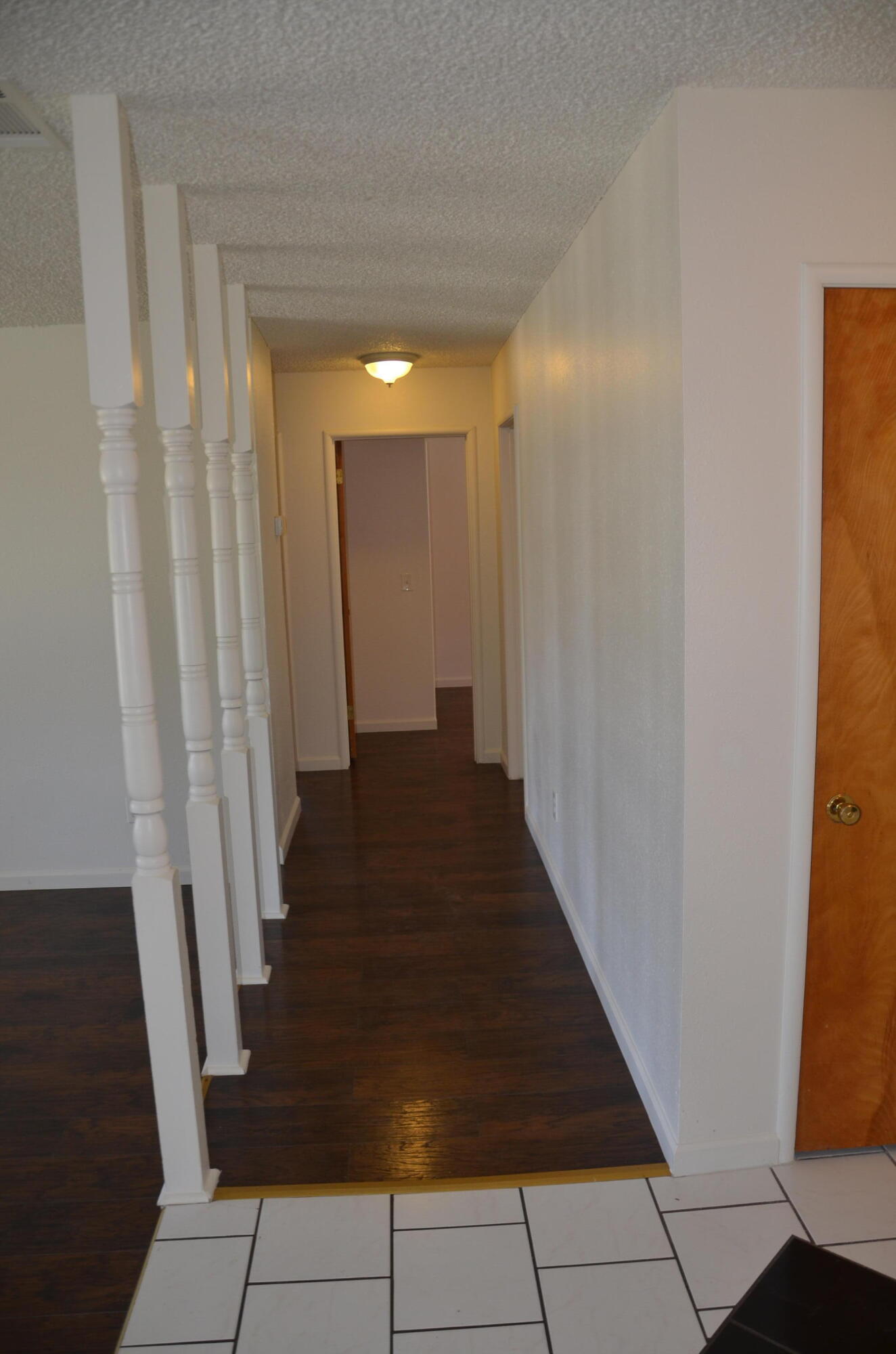 339 West Spring Lane Lemoore, CA 93245 - Photo 15 of 31 a view of a hallway with wooden floor and staircase
