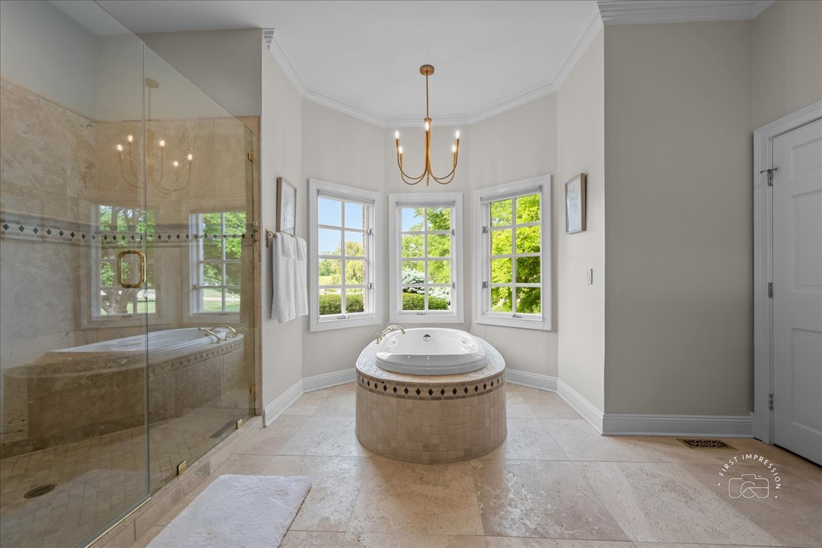 4N749 Old Farm Road St. Charles, IL 60175 - Photo 33 of 46 a spacious bathroom with a granite countertop sink a large mirror and a bathtub