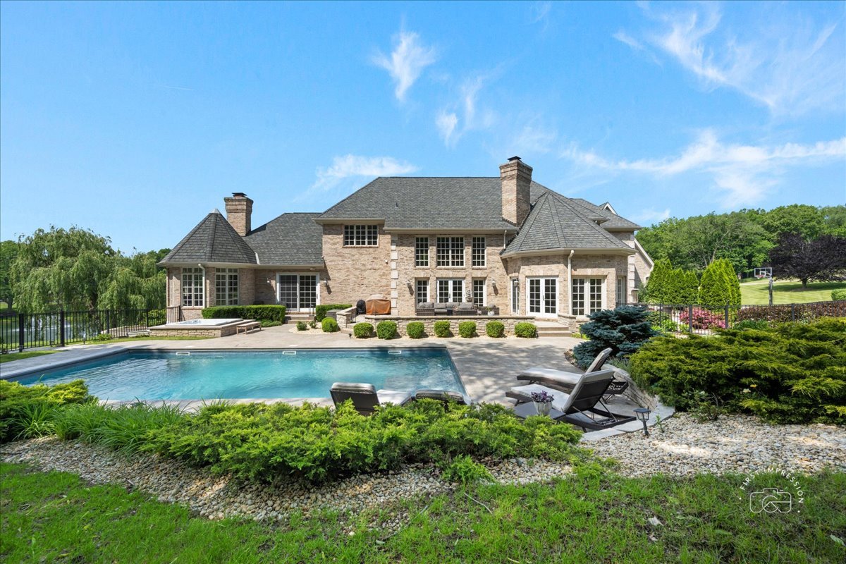 4N749 Old Farm Road St. Charles, IL 60175 - Photo 4 of 46 a front view of a house with swimming pool having outdoor seating
