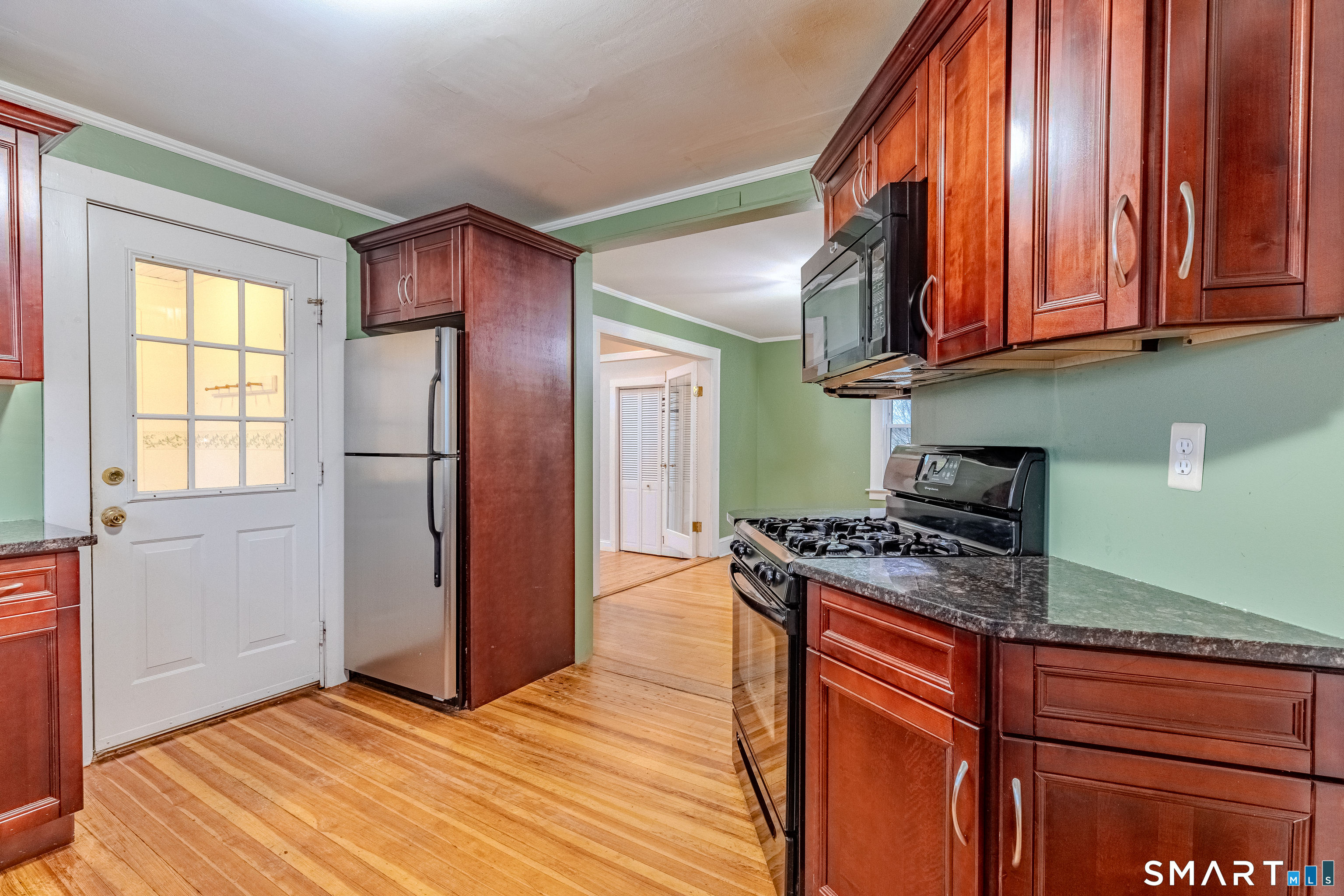 61 Woodmere Road West Hartford, CT 06119 - Photo 11 of 37 a kitchen with stainless steel appliances granite countertop a sink a stove and a refrigerator