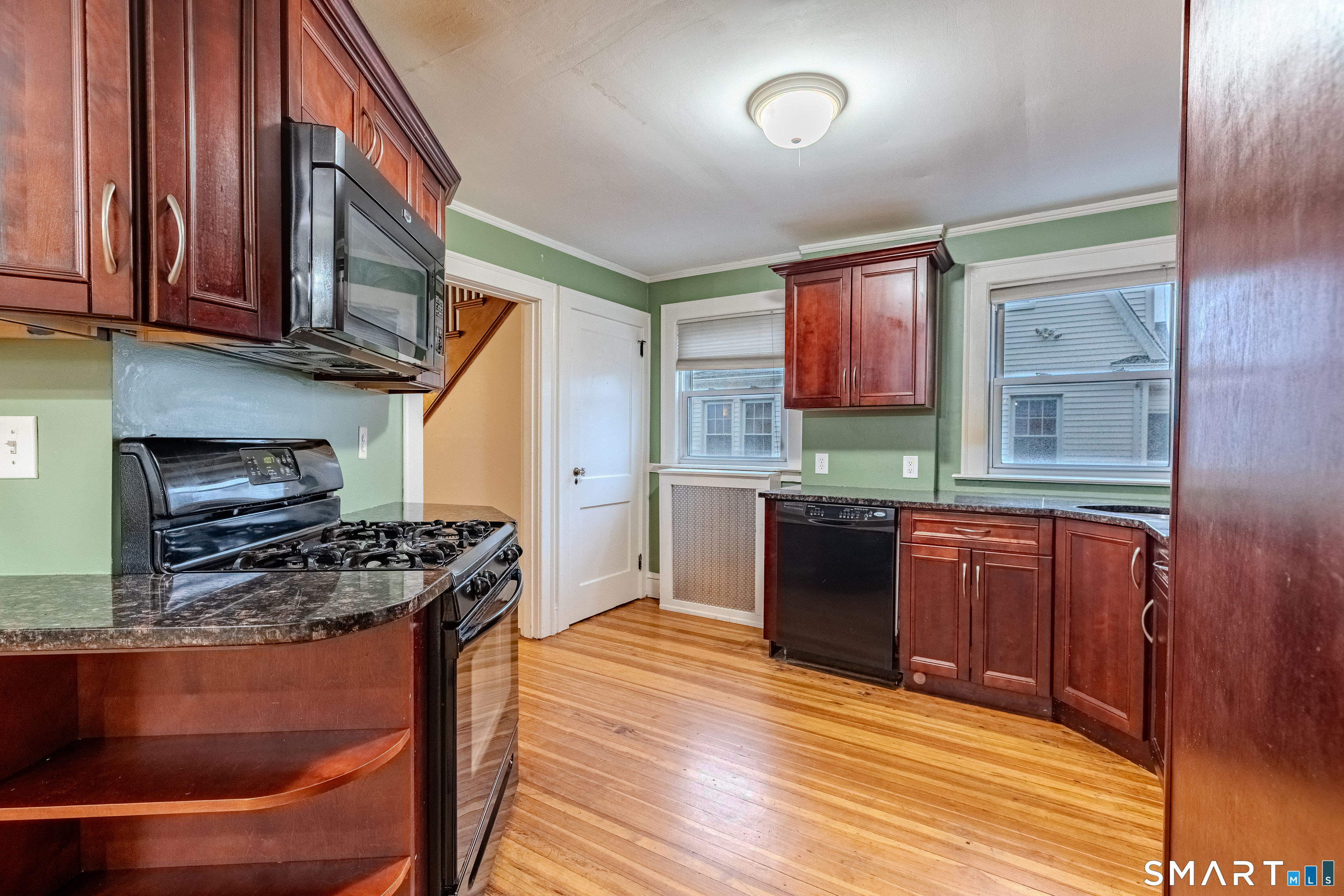61 Woodmere Road West Hartford, CT 06119 - Photo 12 of 37 a kitchen with stainless steel appliances granite countertop a stove a sink and a microwave