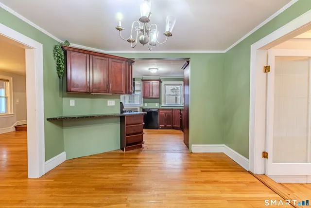 a kitchen with stainless steel appliances granite countertop a refrigerator stove top oven and cabinets