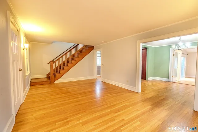 a view of an empty room with wooden floor