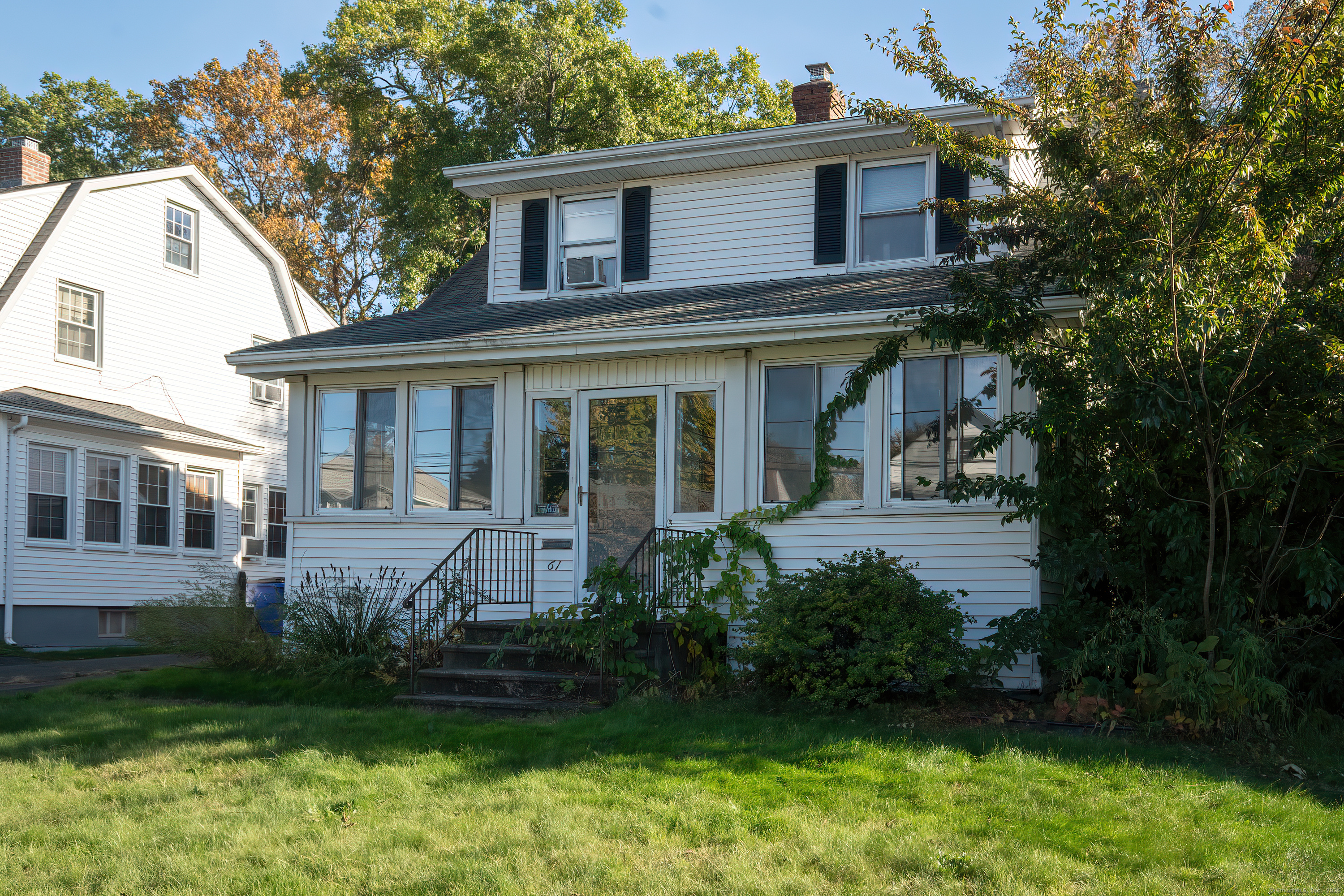 61 Woodmere Road West Hartford, CT 06119 - Photo 2 of 37 a front view of a house with a yard and potted plants