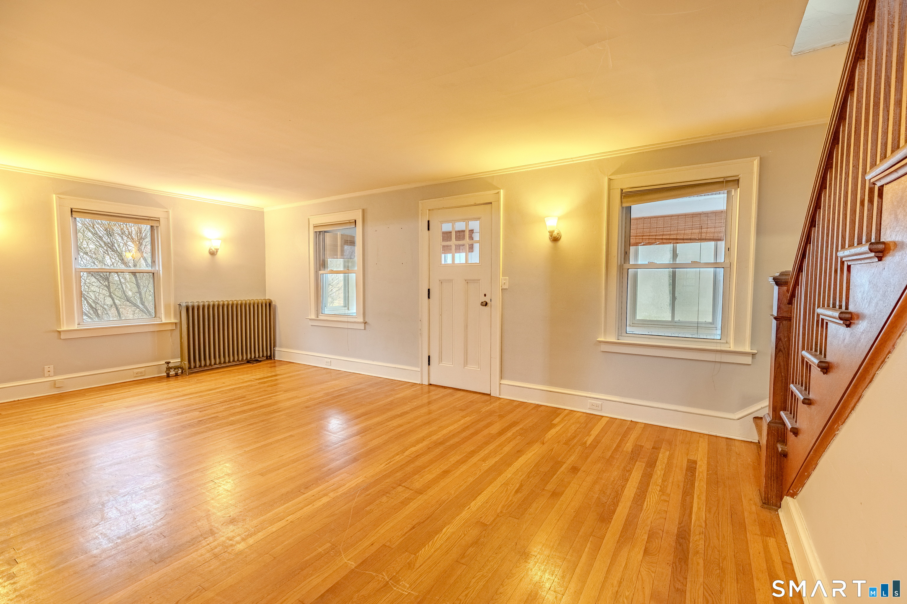 61 Woodmere Road West Hartford, CT 06119 - Photo 21 of 37 a view of an empty room with wooden floor and a window