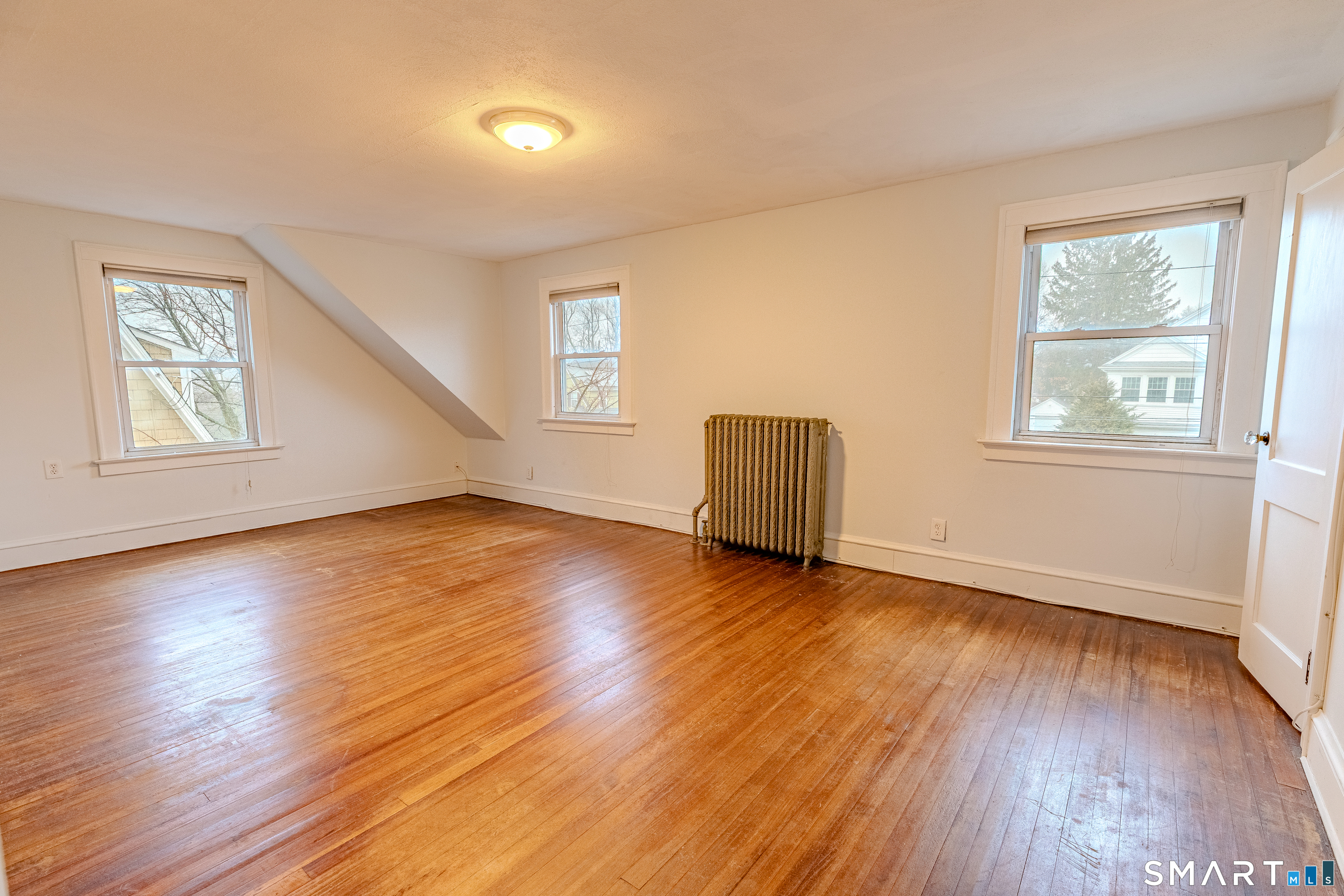 61 Woodmere Road West Hartford, CT 06119 - Photo 23 of 37 a view of empty room with wooden floor and fan