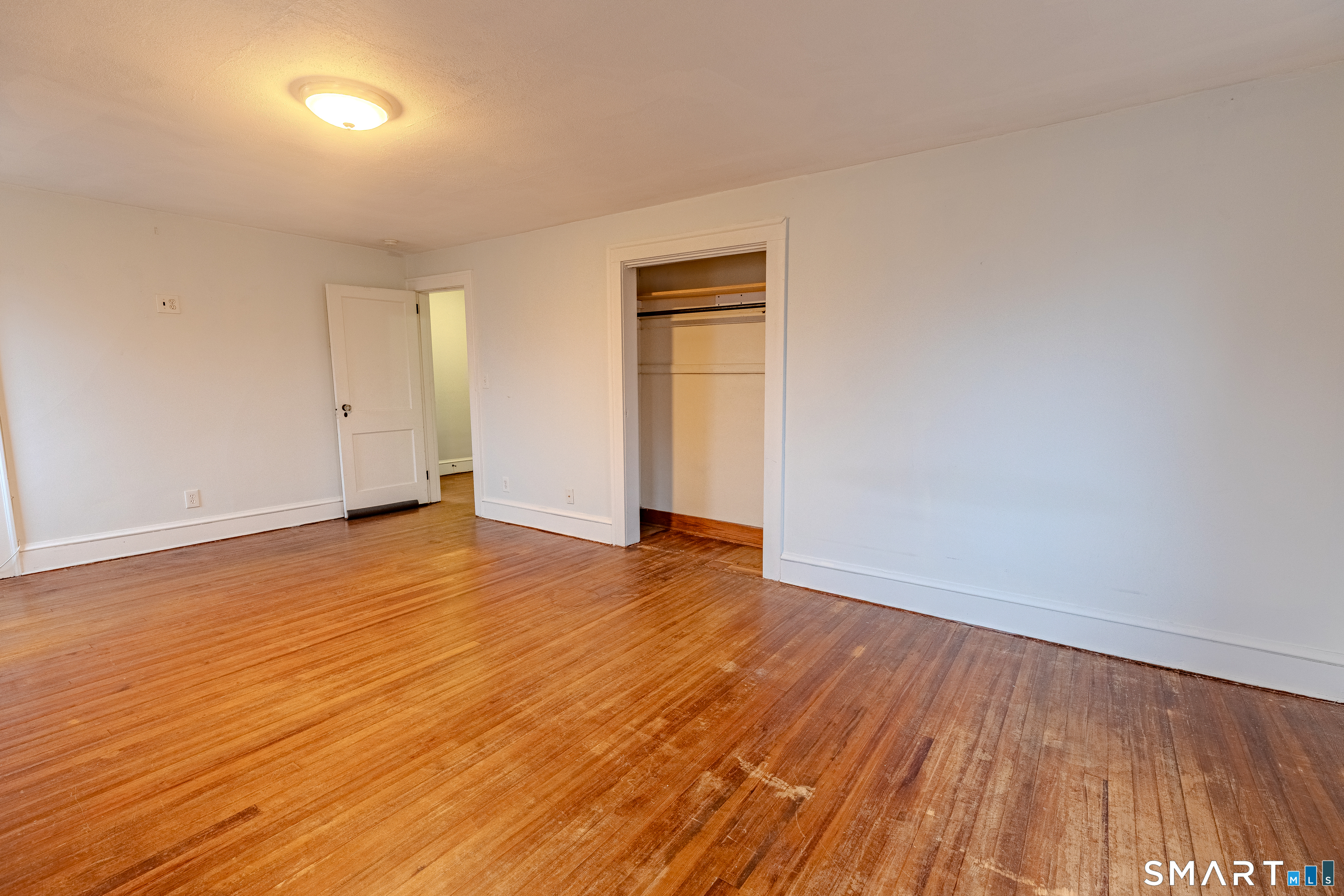 61 Woodmere Road West Hartford, CT 06119 - Photo 24 of 37 a view of an empty room with wooden floor and a window