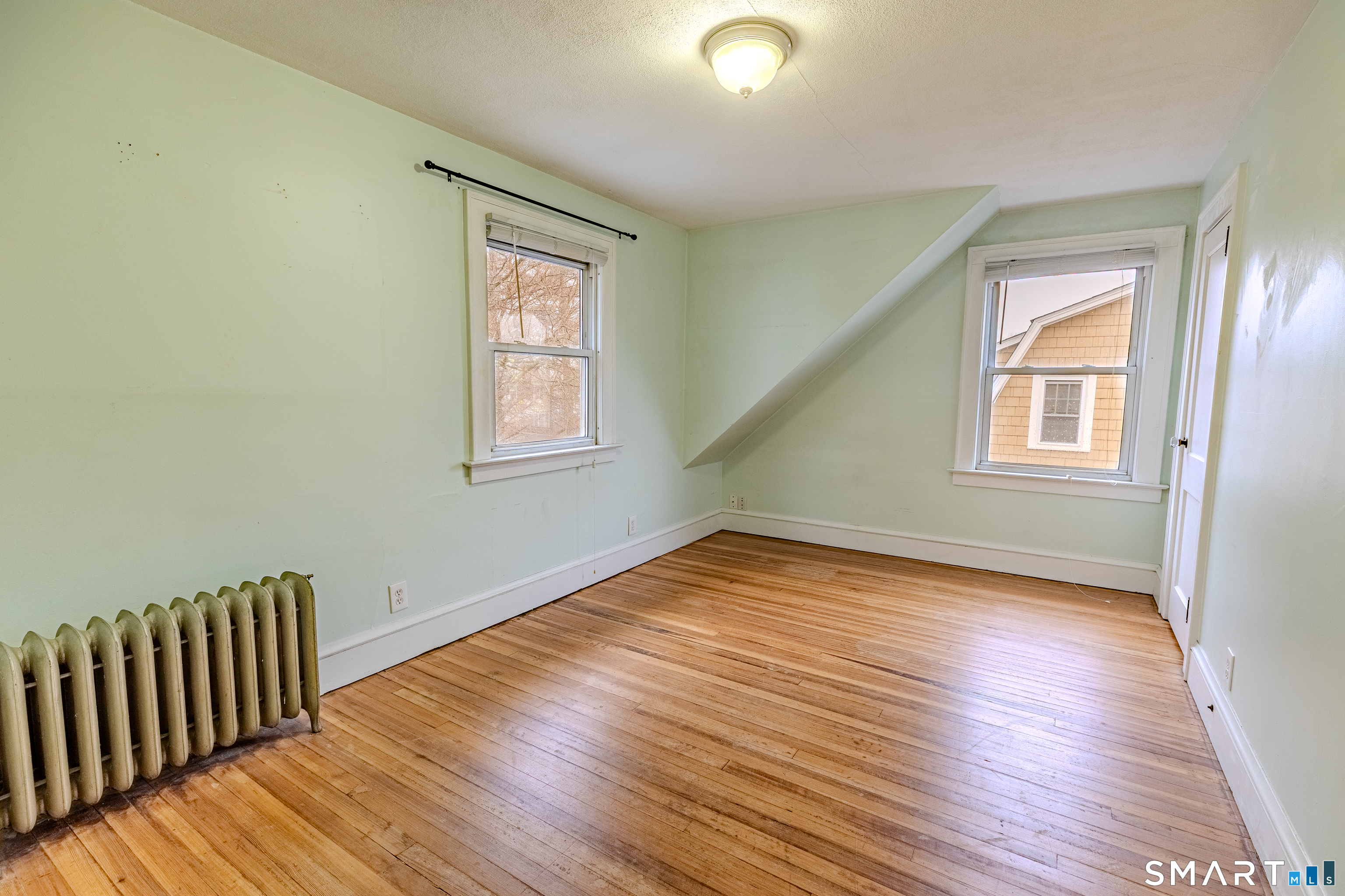61 Woodmere Road West Hartford, CT 06119 - Photo 27 of 37 a view of empty room with wooden floor and fan