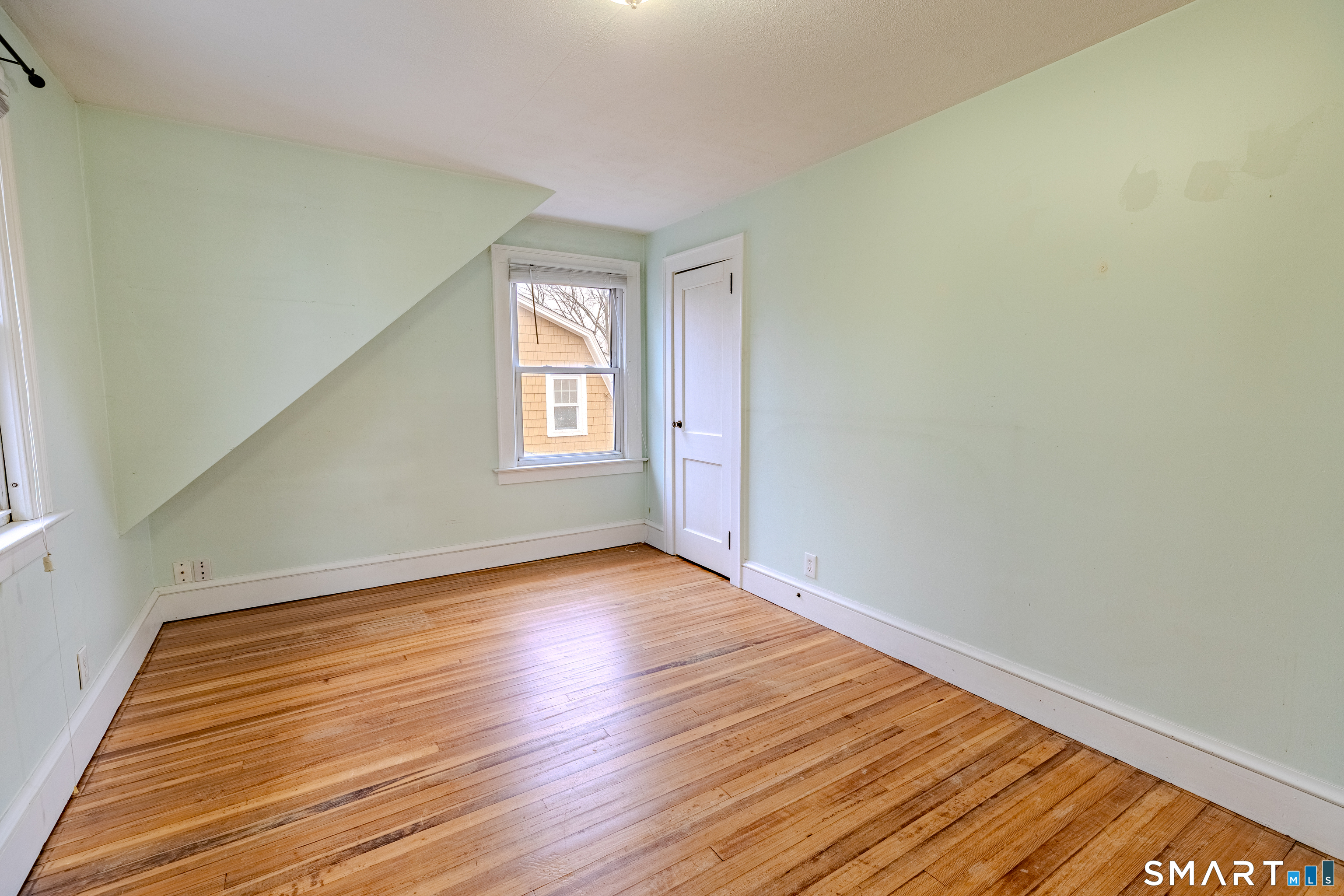 61 Woodmere Road West Hartford, CT 06119 - Photo 30 of 37 a view of an empty room with wooden floor and window