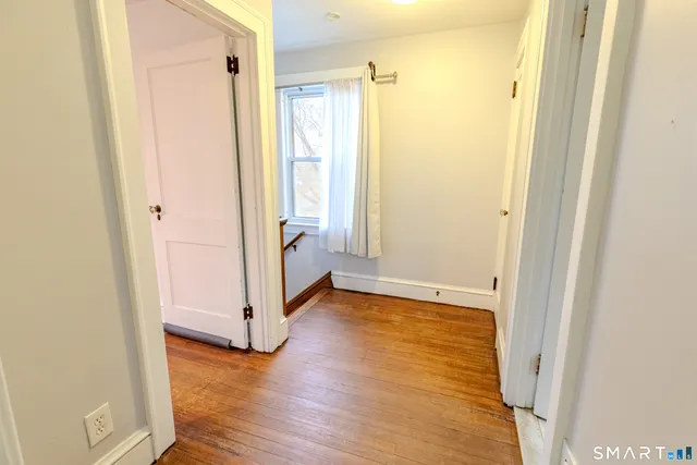 a view of a bathroom with wooden floor