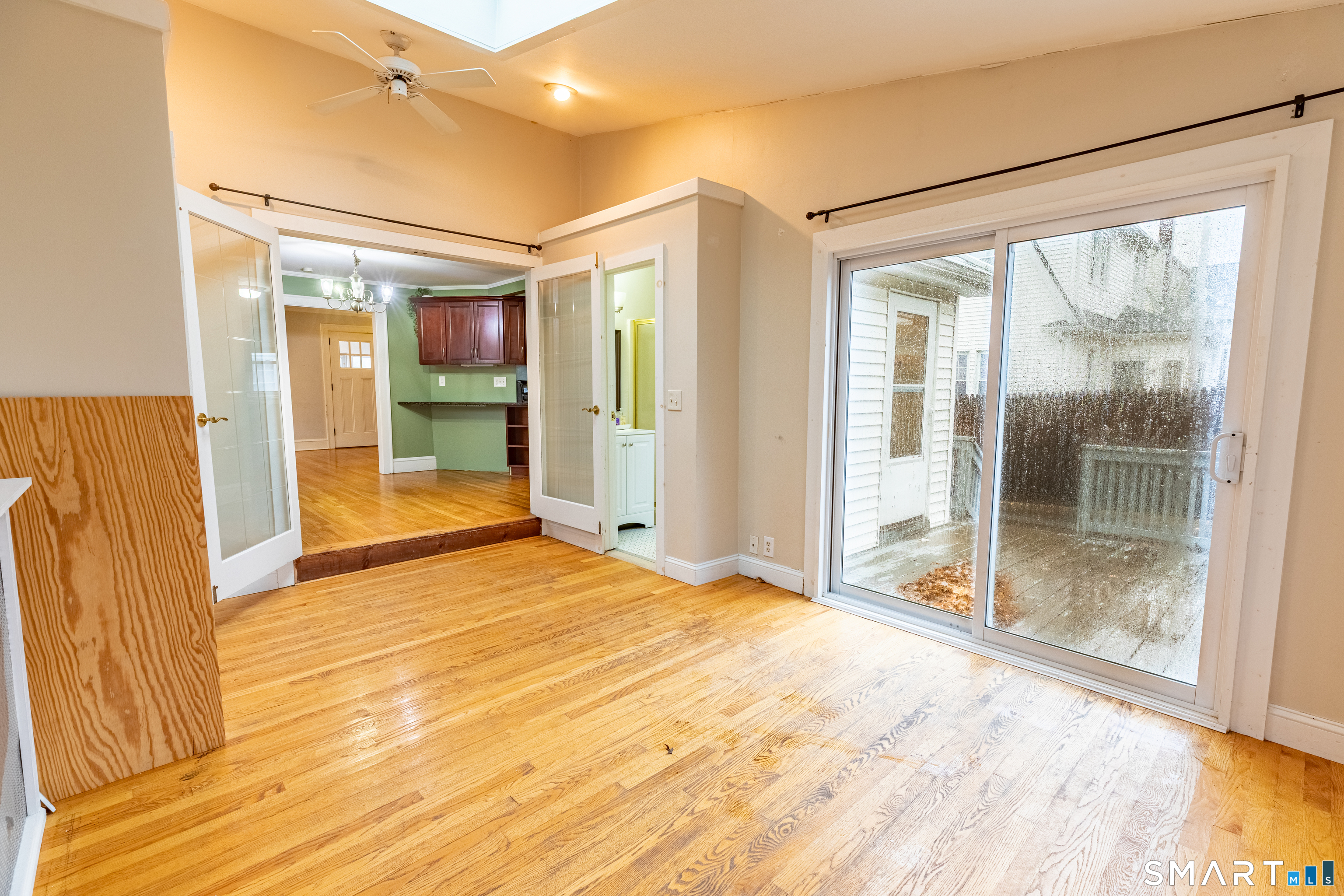 61 Woodmere Road West Hartford, CT 06119 - Photo 33 of 37 a view of empty room with wooden floor and glass door