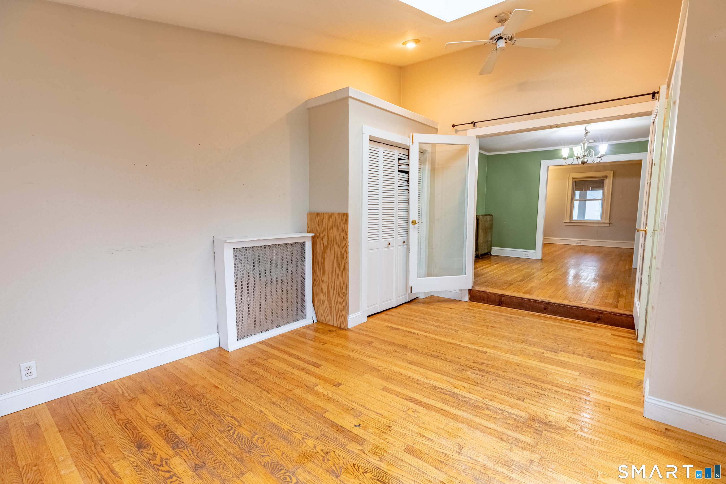 61 Woodmere Road West Hartford, CT 06119 - Photo 34 of 37 a bedroom with a bed and a chandelier