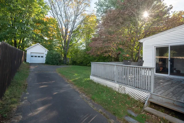 a view of backyard with a deck and a garden