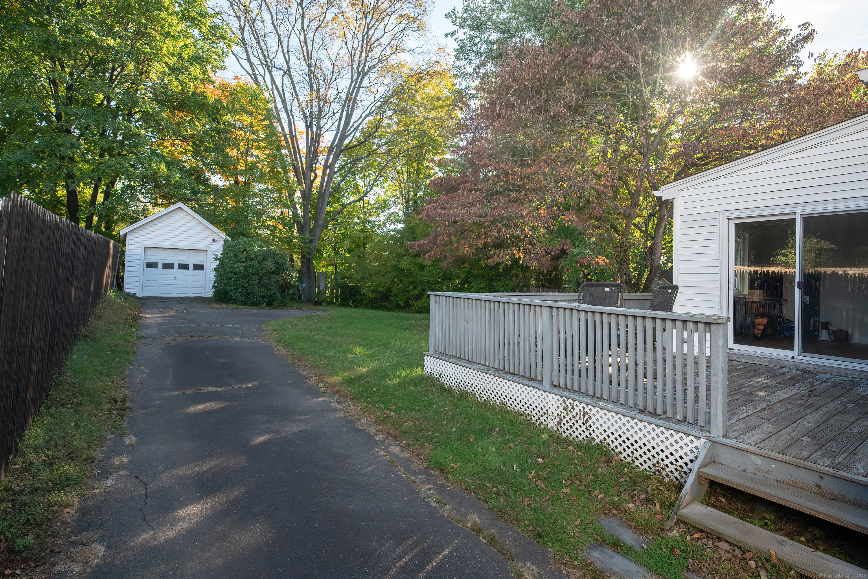 61 Woodmere Road West Hartford, CT 06119 - Photo 8 of 37 a view of backyard with a deck and a garden