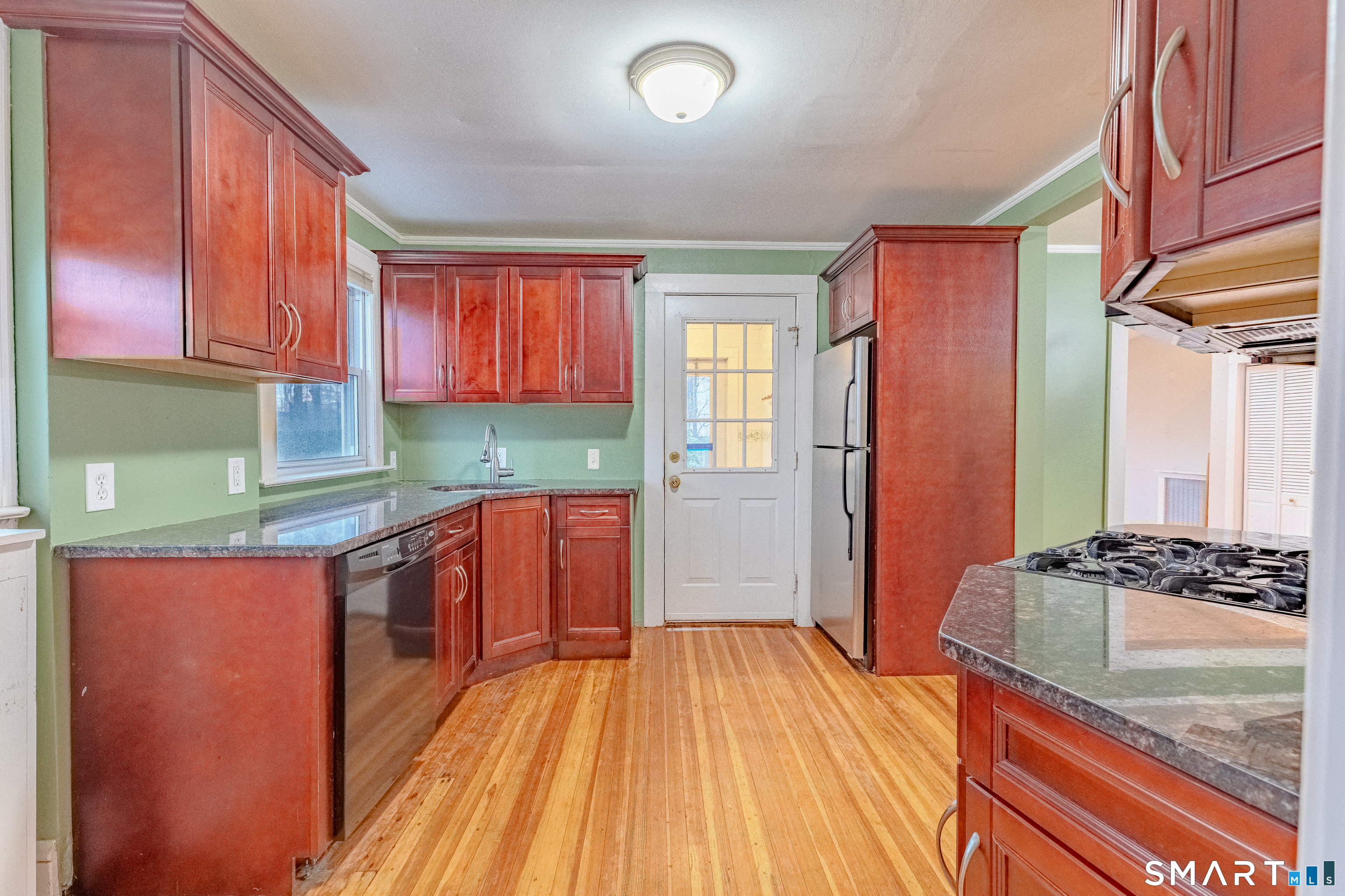 61 Woodmere Road West Hartford, CT 06119 - Photo 10 of 37 a kitchen with stainless steel appliances granite countertop a stove a sink and a refrigerator