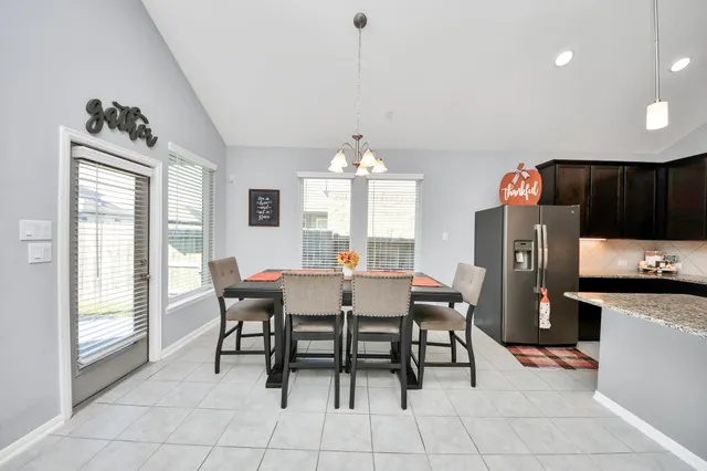 a dining room with furniture and window