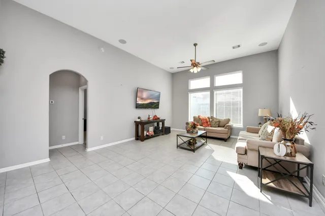 a living room with furniture and a large window