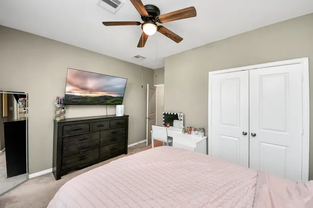 a bedroom with a bed and a flat screen tv