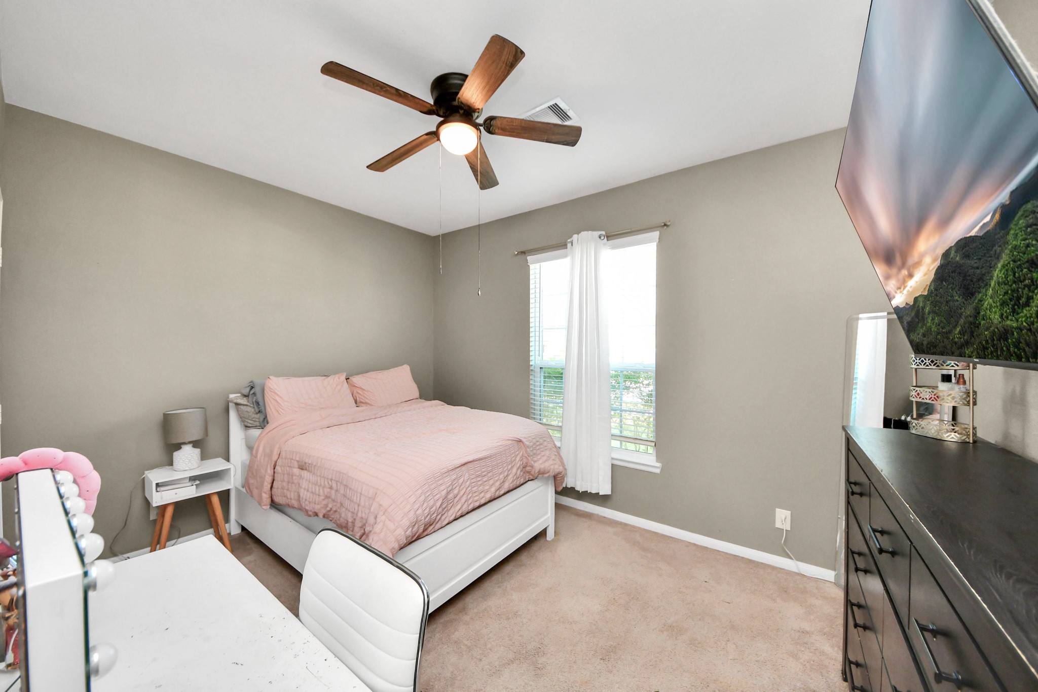 427 Alaska Cedar Drive Crosby, TX 77532 - Photo 4 of 35 a bedroom with a large bed and a chandelier