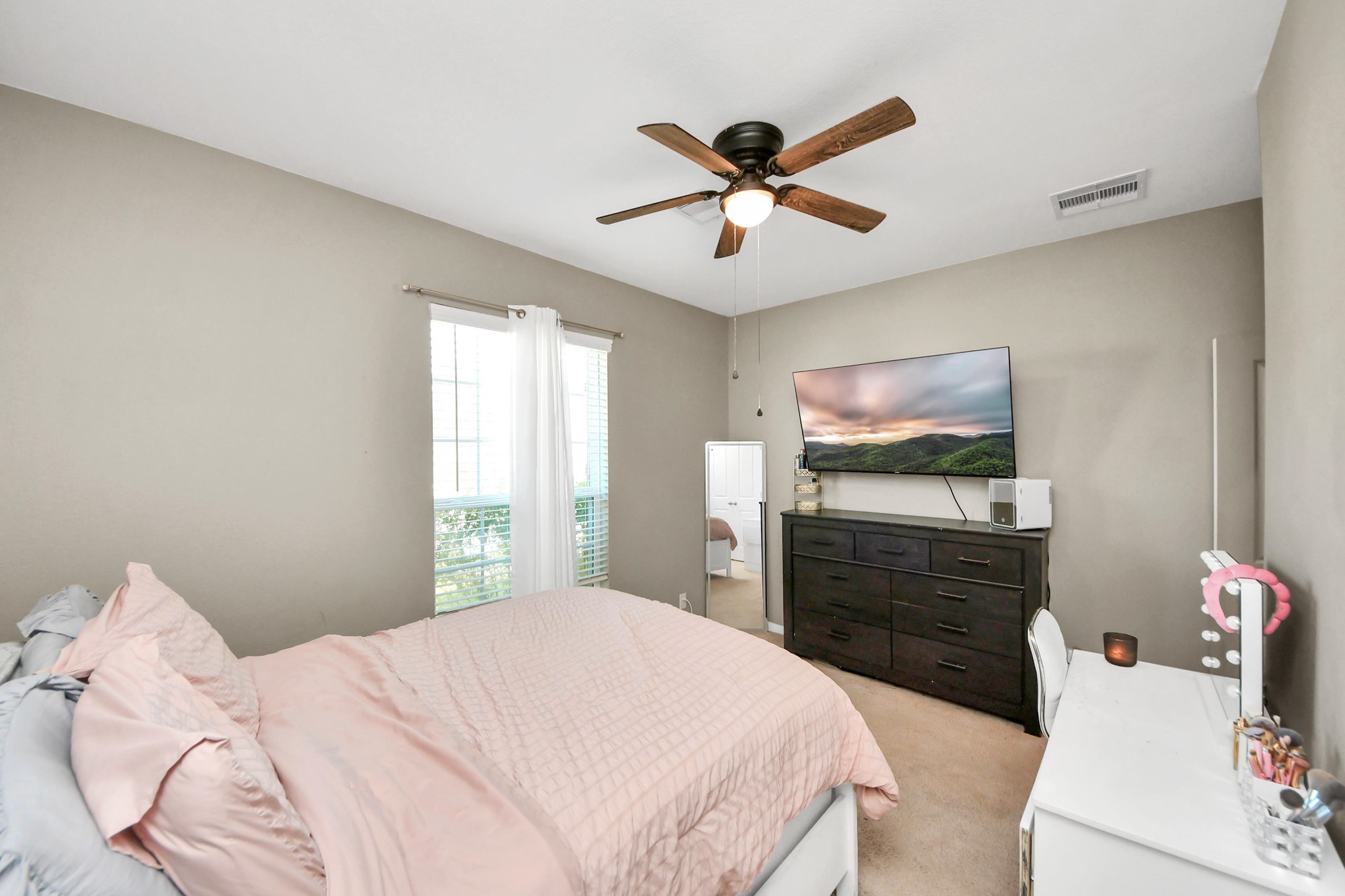 427 Alaska Cedar Drive Crosby, TX 77532 - Photo 5 of 35 a bedroom with a bed and a chandelier