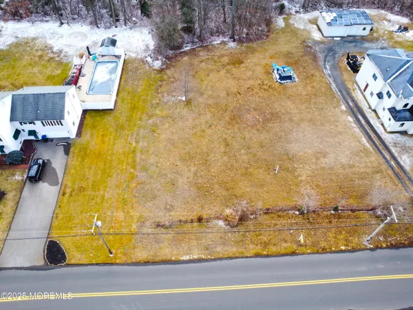 a view of a swimming pool with a lawn chairs under an umbrella