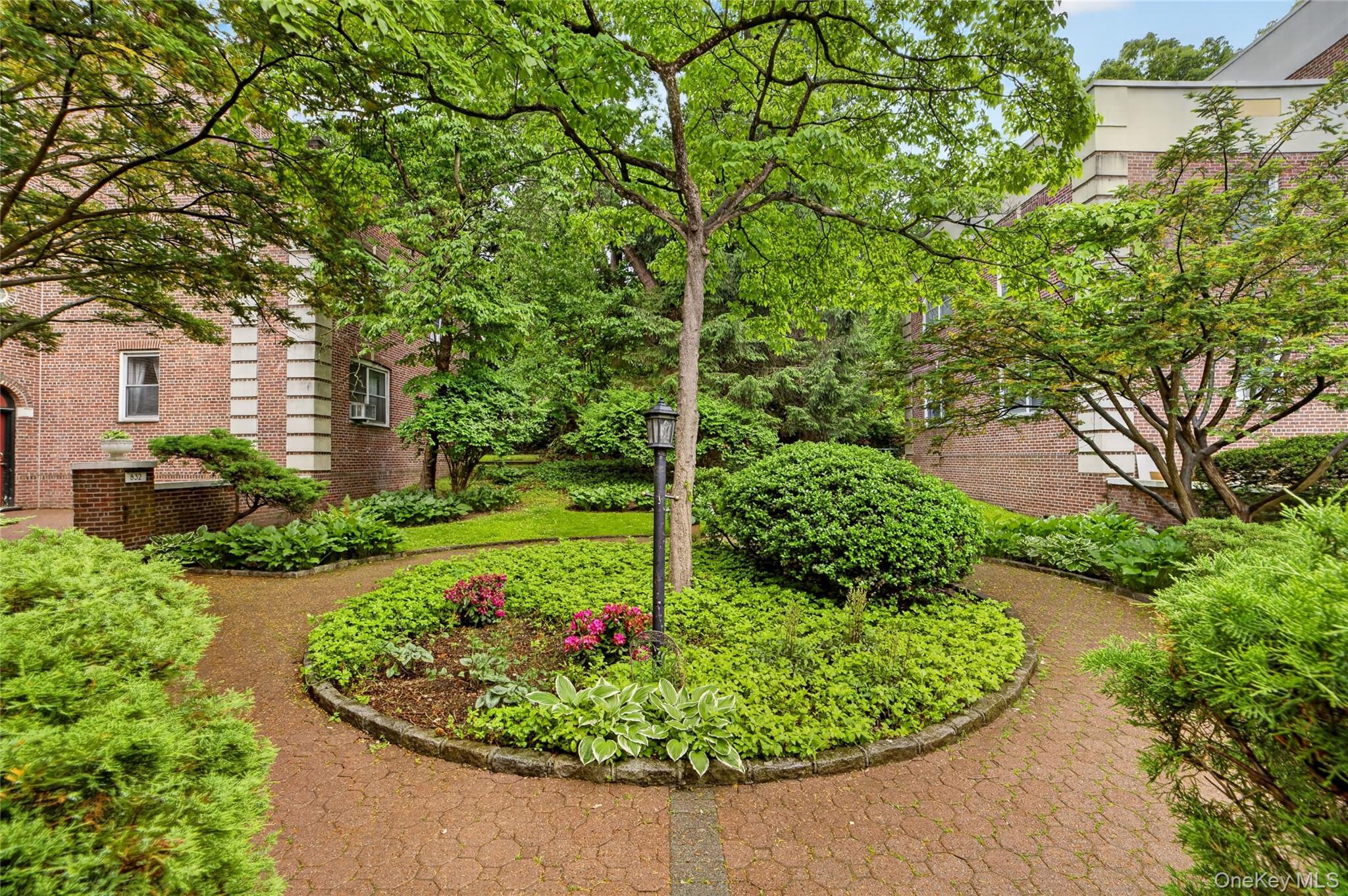 824 Palmer Road, Unit 1F Bronxville, NY 10708 - Photo 25 of 26 a view of a garden with a fountain