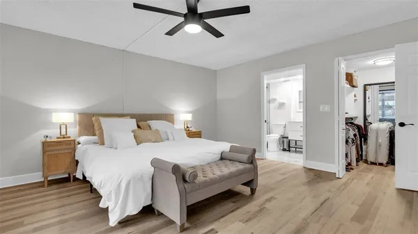 a bedroom with a bed and wooden floor