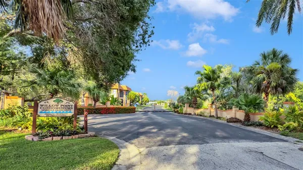 an aerial view of residential houses with outdoor space and lake view