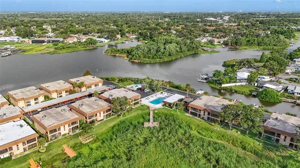 an aerial view of a house with a yard and lake view