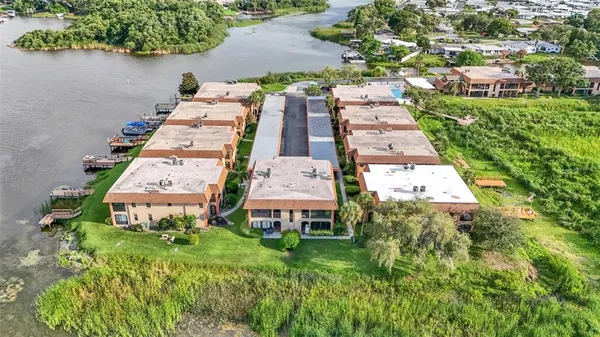 an aerial view of a house with a garden and lake view